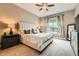 Comfortable main bedroom featuring carpet flooring, a ceiling fan and a window with curtains at 12715 Madison St, Thornton, CO 80241