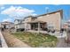 Large backyard with grassy areas, patios, and a built-in fire pit at 6733 S Waterloo Ct, Aurora, CO 80016