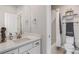 Bright bathroom features a tub with white subway tile surround and a quartz vanity at 6733 S Waterloo Ct, Aurora, CO 80016