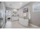 Bright primary bath boasts a modern soaking tub, walk-in shower and double vanity at 6733 S Waterloo Ct, Aurora, CO 80016