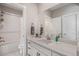Bright bathroom with white subway tile tub surround, and quartz vanity at 6733 S Waterloo Ct, Aurora, CO 80016