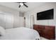 Modern bedroom featuring a dark wood dresser, ceiling fan and closet at 6733 S Waterloo Ct, Aurora, CO 80016
