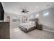 Spacious bedroom featuring a wooden bed frame, neutral walls and a ceiling fan at 6733 S Waterloo Ct, Aurora, CO 80016