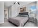 Carpeted bedroom has a window, closet, and gray upholstered bed frame at 6733 S Waterloo Ct, Aurora, CO 80016