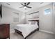 Bright bedroom featuring neutral walls, ceiling fan, and three windows at 6733 S Waterloo Ct, Aurora, CO 80016