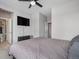 Bedroom with an open door to the bathroom and a large television screen at 6733 S Waterloo Ct, Aurora, CO 80016