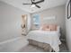 Well-lit bedroom has carpet flooring, ceiling fan, and a view of the neighborhood outside at 6733 S Waterloo Ct, Aurora, CO 80016
