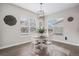 Cozy dining room with bright windows and a modern chandelier at 6733 S Waterloo Ct, Aurora, CO 80016