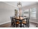 Traditional dining room with a large square table and black and wood chairs at 6733 S Waterloo Ct, Aurora, CO 80016