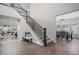 Spacious foyer with staircase, wood floors and easy access to the dining room at 6733 S Waterloo Ct, Aurora, CO 80016