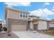 Attractive home featuring a stone facade and two-car garage, set against a bright blue sky at 6733 S Waterloo Ct, Aurora, CO 80016