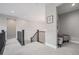 Bright hallway features neutral walls, railing and carpet with bonus room to the side at 6733 S Waterloo Ct, Aurora, CO 80016