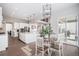 A modern eat-in kitchen featuring a center island, stainless steel appliances, hardwood floors, and ample natural light at 6733 S Waterloo Ct, Aurora, CO 80016