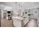 Open-concept kitchen with a large island, stainless steel appliances, and living area with a fireplace at 6733 S Waterloo Ct, Aurora, CO 80016