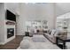 Bright living room with fireplace, high ceilings, and comfortable seating area at 6733 S Waterloo Ct, Aurora, CO 80016