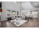 Open living room with high ceilings, large windows, and modern furnishings at 6733 S Waterloo Ct, Aurora, CO 80016
