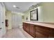 Well-lit bathroom with dark wood cabinetry and a shower/tub combo at 6681 Flintwood Rd, Parker, CO 80138