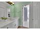Light and airy bathroom featuring neutral tile, charming fixtures, and plenty of storage at 6681 Flintwood Rd, Parker, CO 80138