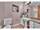 Bathroom with pedestal sink, wood look flooring, and decorative accents at 6681 Flintwood Rd, Parker, CO 80138