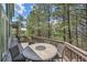 Outdoor deck with seating area perfect for entertaining and overlooking the trees at 6681 Flintwood Rd, Parker, CO 80138