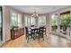 Dining area features plantation shutters, wood floors, stylish accents, and access to outdoor deck at 6681 Flintwood Rd, Parker, CO 80138