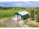 Aerial view of a large, green garage with two bays situated on a grassy lot with mountain views at 6681 Flintwood Rd, Parker, CO 80138