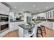 Kitchen with island seating, stainless appliances, granite counters, and open view to Gathering room at 6681 Flintwood Rd, Parker, CO 80138