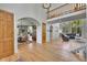 Bright, open-concept living area with hardwood floors, arched doorways, and a cozy atmosphere at 6681 Flintwood Rd, Parker, CO 80138