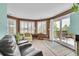 Comfortable living room featuring large windows, sliding glass door access to the deck, and plush seating at 6681 Flintwood Rd, Parker, CO 80138