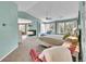 Bright primary bedroom with seating area, fireplace, carpet and wooded views at 6681 Flintwood Rd, Parker, CO 80138