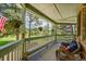Comfortable covered porch with seating and a view of the lovely landscaped yard at 6681 Flintwood Rd, Parker, CO 80138