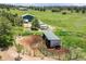 Aerial view featuring horse property with a barn, paddocks, and lush pasture at 6681 Flintwood Rd, Parker, CO 80138