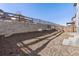 Landscaped backyard with a retaining wall and a wooden fence at 15792 E Otero Cir, Centennial, CO 80112