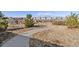 Curved concrete pathway meandering through a grassy area with homes in the distance at 15792 E Otero Cir, Centennial, CO 80112