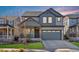 Two-story house with gray siding, landscaping, and a two-car garage at 15792 E Otero Cir, Centennial, CO 80112