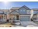 Two-story house with gray siding, landscaping, and a two-car garage at 15792 E Otero Cir, Centennial, CO 80112