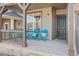 Covered porch with teal chairs and cushions, offering a relaxing outdoor space at 15792 E Otero Cir, Centennial, CO 80112