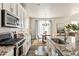 Modern kitchen with white cabinets, granite counters and breakfast nook at 15792 E Otero Cir, Centennial, CO 80112