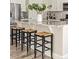 Kitchen island with granite countertop and three barstools at 15792 E Otero Cir, Centennial, CO 80112