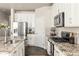 Modern kitchen with white cabinets and granite countertops at 15792 E Otero Cir, Centennial, CO 80112