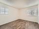 Bright and airy bedroom featuring new floors and ample natural light from two windows at 14131 E Jewell Ave # 104, Aurora, CO 80012