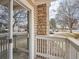 Cozy patio area with a stone support column and white railing, offering a relaxing outdoor space at 14131 E Jewell Ave # 104, Aurora, CO 80012