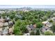 Scenic aerial view of a neighborhood, showcasing tree-lined streets and the Denver skyline in the distance at 2975 Irving St, Denver, CO 80211