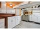 Basement area features white cabinets, and a sink with wooden countertop at 2975 Irving St, Denver, CO 80211