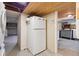 Spacious basement area features a white refrigerator and access to storage at 2975 Irving St, Denver, CO 80211