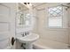 Bathroom with a pedestal sink, subway tile, and a shower and tub with dual shower heads at 2975 Irving St, Denver, CO 80211