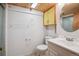 Bathroom features a toilet, sink, mirror, and a shower at 2975 Irving St, Denver, CO 80211