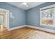 Bedroom with hardwood floors, large window, and classic trim at 2975 Irving St, Denver, CO 80211