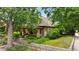 Two-story home with a brick facade, covered porch, mature trees, and a well-kept front yard at 2975 Irving St, Denver, CO 80211