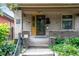 Front entrance with a decorative door, mailbox, and house number, framed by brick columns at 2975 Irving St, Denver, CO 80211